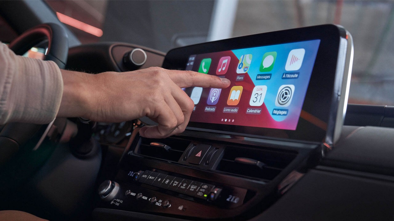 A person using the Lexus ES 300h's touchscreen display 