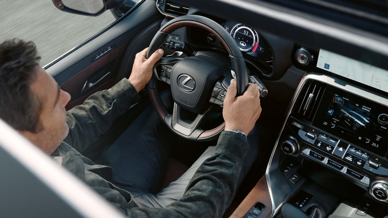 A raised view of a man driving a Lexus LX 