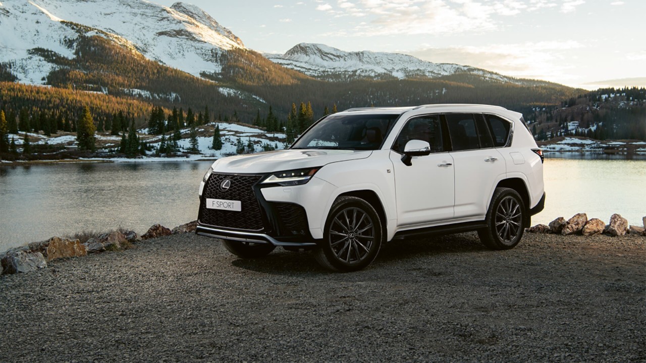 A Lexus LX parked in front of a lake