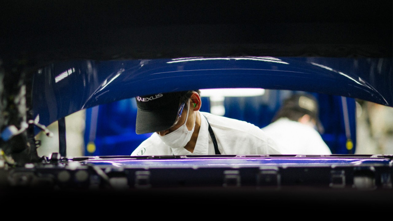 Lexus engineer working on an engine 